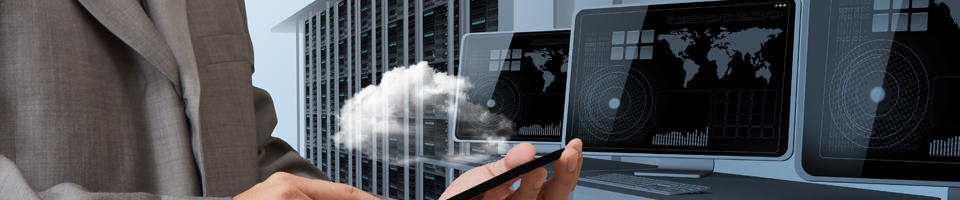 Man holding cellphone with cloud coming above it and computers in background